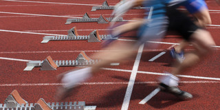 Starting Signal Several Sprinter are starting side by side from starting blocks.