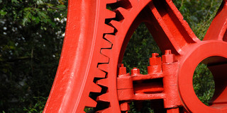 Gears Campus North_02 The teeth of two large red steel gears get caught.
